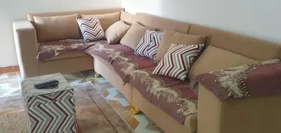 a couch with pillows on it in a room at Seashell in Quseir