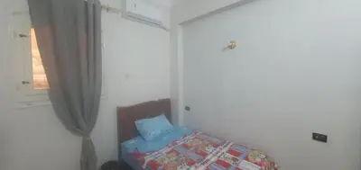 a bedroom with a bed and a window at Seashell in Quseir