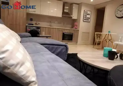 a living room with two beds and a table at Warm 1BR with @ Mangroovy, El-Gouna M1-7B in Hurghada