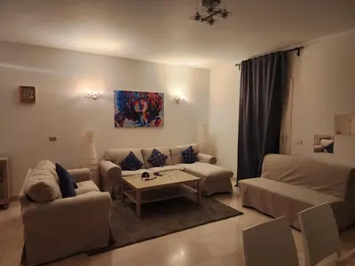 a living room with two couches and a coffee table at Elgouna - Directly To The Marina in Hurghada