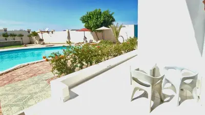 a villa with a swimming pool and a house at La BONITA FLAT in Hurghada