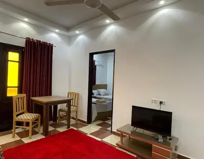 a living room with a television and a table and a mirror at White Star House in Safaga