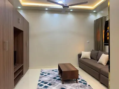 a living room with a couch and a ceiling fan at White Star House in Safaga