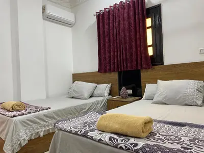 a room with two beds and a window at White Star House in Safaga