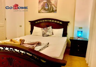 a bedroom with a bed with a teddy bear on it at Friendly 1 Bed Room Y12 -0 West Golf at El-Gouna in Hurghada