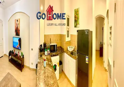 a kitchen with a black refrigerator and a counter at Friendly 1 Bed Room Y12 -0 West Golf at El-Gouna in Hurghada