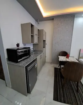 a kitchen with a stove and a microwave at Juliana beach resort in el ahead st in El Gouna