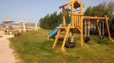 a playground with a slide and a slide at Fox house resort Apartment hotel in Hurghada