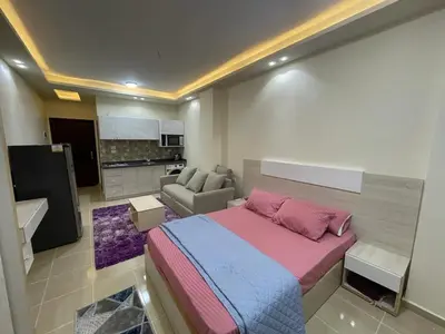 a bedroom with a bed and a living room at Casablanca star Beach Hurghada كازابلانكا ستار بيتش الغردقة in Hurghada