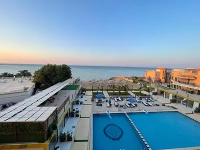 a view of a resort with a swimming pool and the ocean at Casablanca star Beach Hurghada كازابلانكا ستار بيتش الغردقة in Hurghada