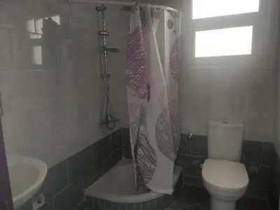 a bathroom with a toilet and a shower and a sink at La bonita studio in Hurghada