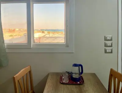 a table with a blender on it next to a window at Divers Home Safaga in Safaga