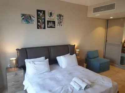 a bedroom with a large bed with towels on it at Mangroovy - 2BR Prodigious Ground Pool & Sea view in Hurghada