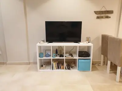 a white entertainment center with a flat screen tv at Mangroovy- 1BR Sea Breeze Back Sea view in Hurghada