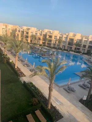 an overhead view of a large swimming pool with palm trees at Mangroovy- 1BR Sea Breeze Back Sea view in Hurghada
