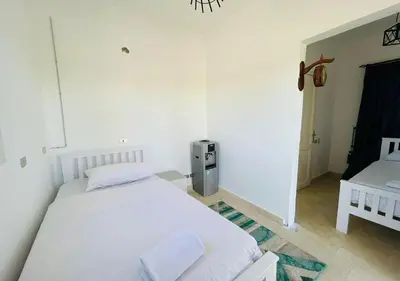 a white bedroom with a bed and a desk at Unique Villa 6 B Rooms Villa 38 at El-Gouna in Hurghada