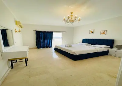 a large bedroom with a bed and a chandelier at Unique Villa 6 B Rooms Villa 38 at El-Gouna in Hurghada