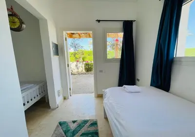 a bedroom with a bed and a door to a yard at Unique Villa 6 B Rooms Villa 38 at El-Gouna in Hurghada