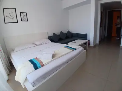 a large white bed in a white room at Hotel Apartment in G cribs in Hurghada