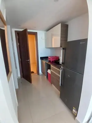 a kitchen with a refrigerator and a counter top at Hotel Apartment in G cribs in Hurghada