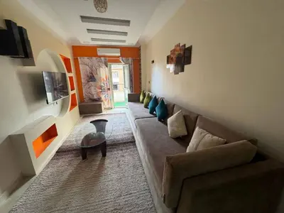 a living room with a couch and a table at Hurghada Sea View Apartment in Hurghada