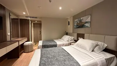 a hotel room with two beds and a television at book Now Nile Cruise From Aswaon every Friday & Monday & wednesday in Aswan