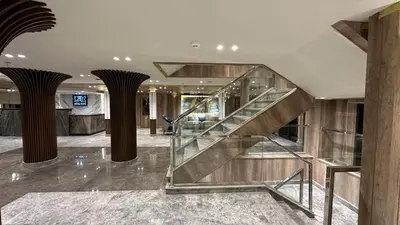 a lobby with a staircase in a building at book Now Nile Cruise From Aswaon every Friday & Monday & wednesday in Aswan
