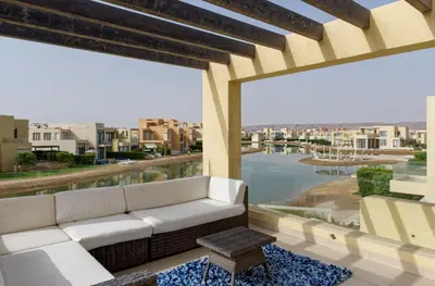 a couch on a patio with a view of the water at Vesta - El Gouna Residence in Hurghada