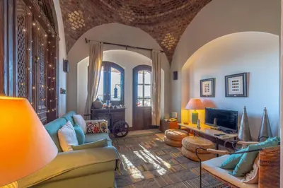 a living room with a couch and a tv at Soulful 1BR in Italian Compound / Nubia, El Gouna in Hurghada