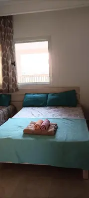 a bedroom with two towels on a bed with a window at Relaxing open Seaview Apartment in Hurghada