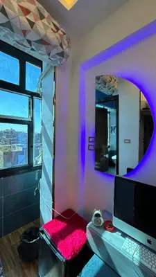 a room with a desk with a computer and a mirror at Unique studio in Aswan
