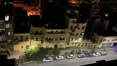 an overhead view of a building with cars parked in a parking lot at Unique studio in Aswan