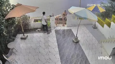 two men are standing on a patio with umbrellas at Esmerada in Aswan