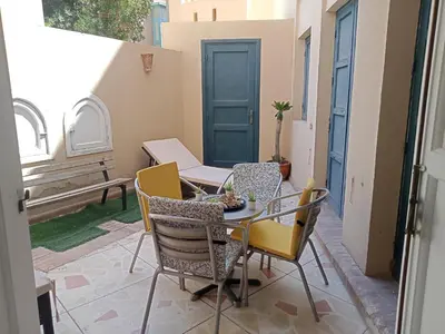 a patio with a table and chairs on a patio at Abutig Marina flat ground floor in Hurghada