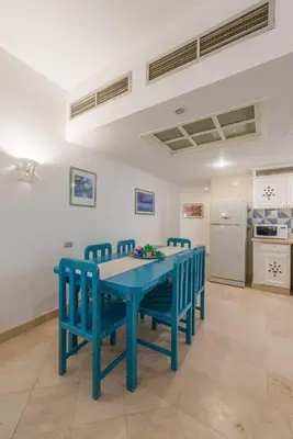 a blue table and chairs in a kitchen at Abutig Marina flat ground floor in Hurghada