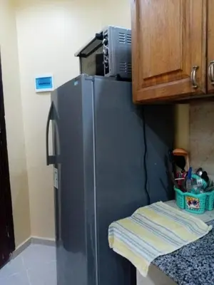 a kitchen with a stainless steel refrigerator in a kitchen at Kazpilkna Beach Neighborhoods in Hurghada
