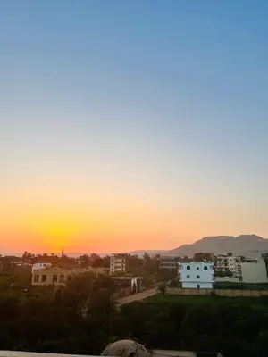 a sunset over a city with houses and buildings at Muhammad Ali House in Luxor