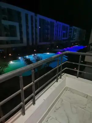 a view of a pool from a balcony at night at Fanadir Bay Resort in Hurghada