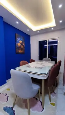 a dining room with a white table and chairs at Fanadir Bay Resort in Hurghada