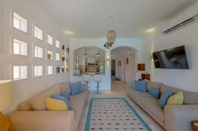 a living room with two couches and a tv at Charming Apartment with Pool in prime location in Hurghada