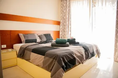 a bedroom with a bed with two towels on it at Apartment with large terrace & nice pool area in Hurghada