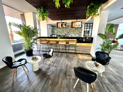 a restaurant with chairs and a bar with plants at Studio Sleeps 2 with Balcony Pool & Parking in Hurghada