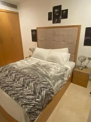 a bed with a zebra print sheets and pillows at one bedroom scarab club el gouna in Hurghada