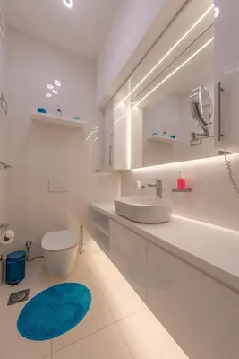 a white bathroom with a sink and a toilet at Special style apartment with pool at lagoon in Hurghada