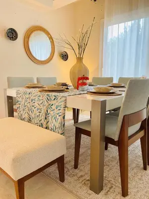 a dining room table with chairs and a vase on it at 4BR Villa with Private Pool in Gouna in Hurghada
