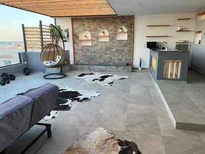 a living room with a cow rug on the floor at Sallam Lux Property in Hurghada
