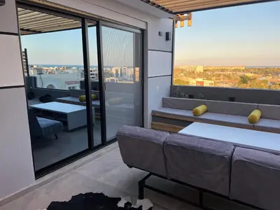 a living room with a couch and a large window at Sallam Lux Property in Hurghada