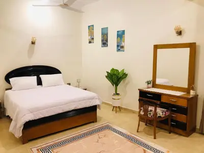 a bedroom with a bed and a mirror and a dresser at joy house in Luxor