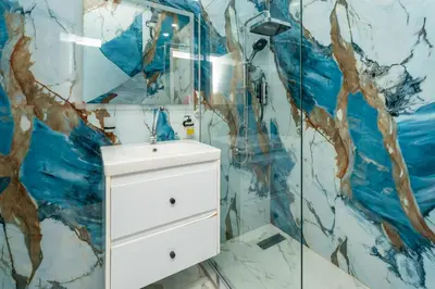 a bathroom with a shower and a white sink at Hurghada apartment luxury 001 in Hurghada