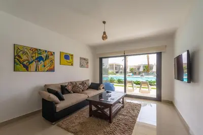a living room with a couch and a table at El Gouna Luxury flat on the pool in El Gouna
